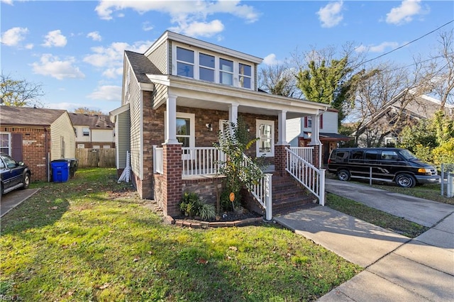 view of front of property featuring a porch and a front lawn