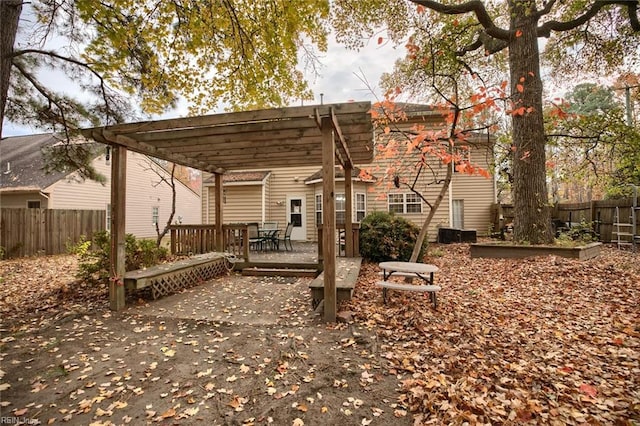 back of property with a pergola and a deck