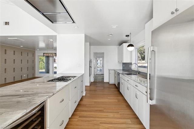 kitchen featuring white cabinetry, plenty of natural light, and stainless steel appliances