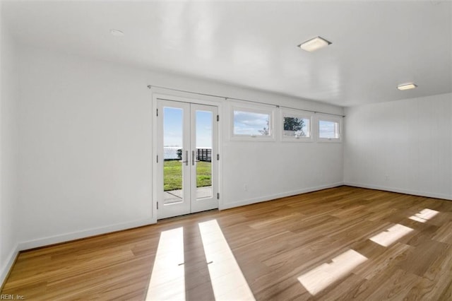 interior space with french doors and light hardwood / wood-style floors