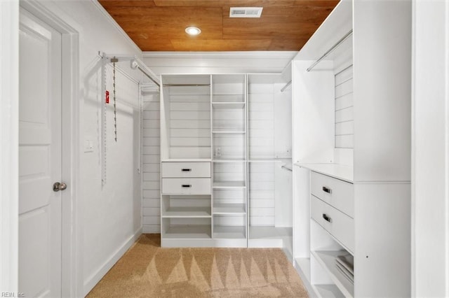 walk in closet featuring light carpet