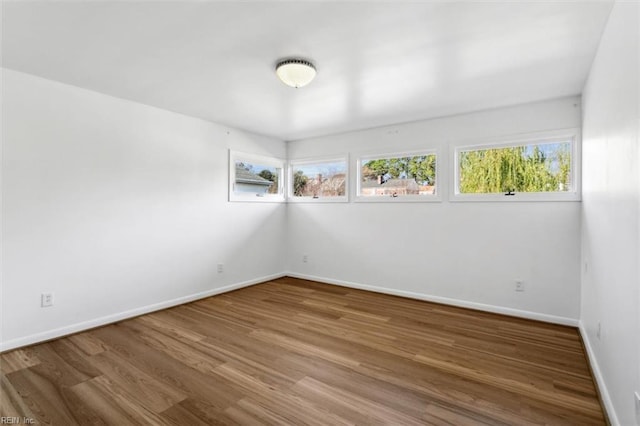 empty room with hardwood / wood-style flooring