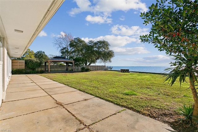 view of yard featuring a gazebo and a water view