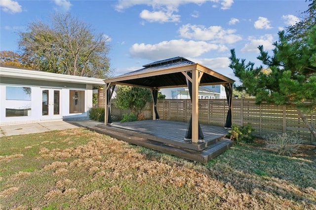 view of yard featuring a gazebo, french doors, and a deck