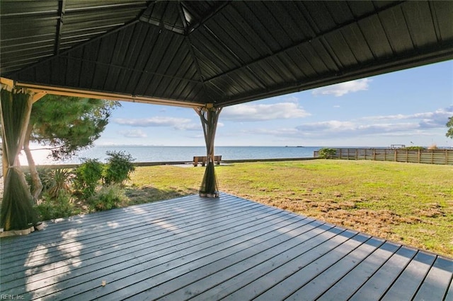 wooden terrace featuring a gazebo, a yard, and a water view