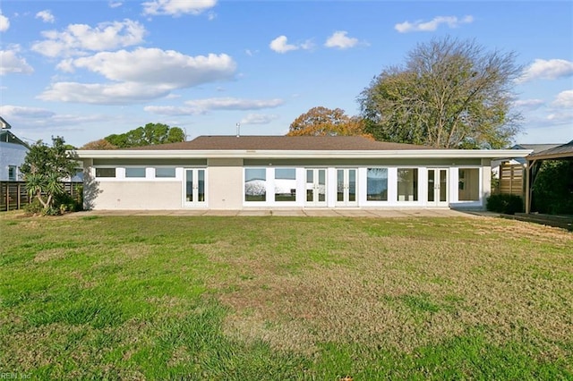 back of property featuring a lawn and french doors