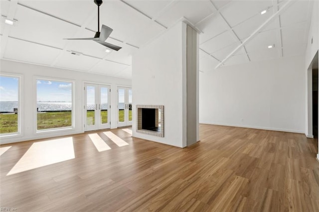 unfurnished living room featuring a fireplace, hardwood / wood-style floors, and ceiling fan