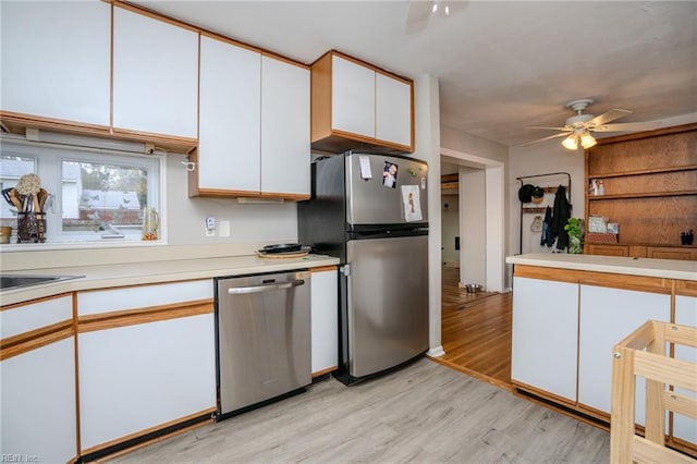 kitchen featuring white cabinetry, light hardwood / wood-style flooring, ceiling fan, and stainless steel appliances