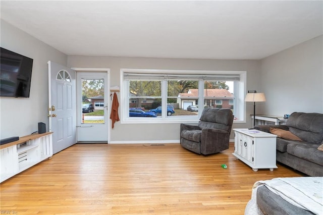 living room featuring plenty of natural light and light hardwood / wood-style floors