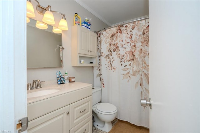 bathroom featuring tile patterned floors, crown molding, vanity, and toilet