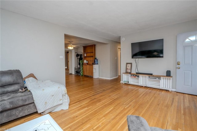 living room featuring ceiling fan and hardwood / wood-style floors