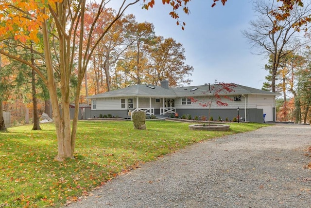 ranch-style home with a front yard and a garage