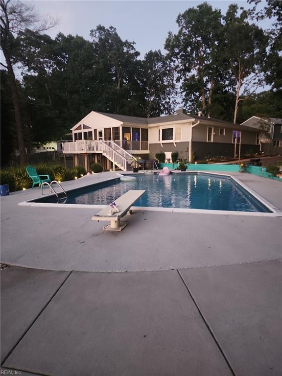 view of pool with a diving board