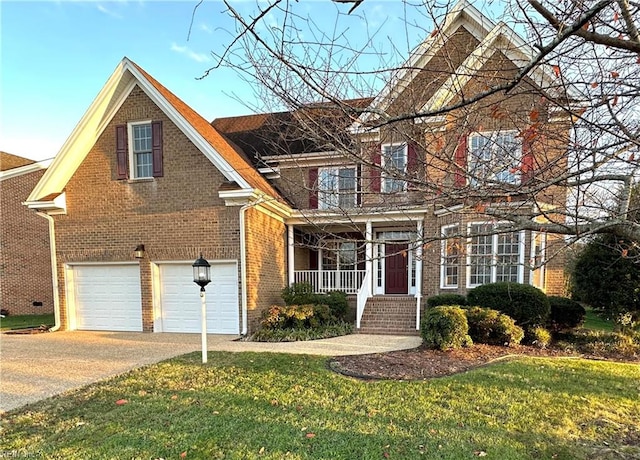 view of front property with a porch, a garage, and a front lawn