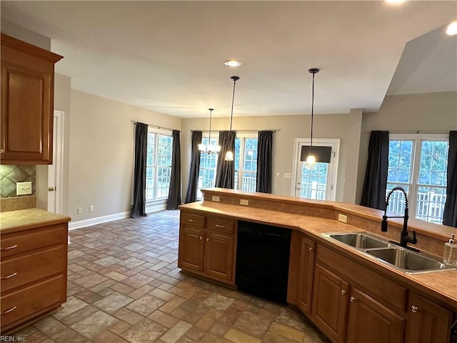 kitchen featuring dishwasher, decorative backsplash, a wealth of natural light, and sink