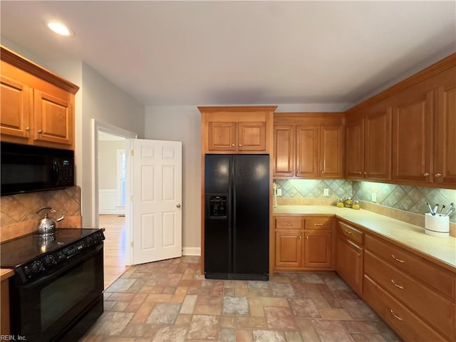 kitchen featuring tasteful backsplash and black appliances