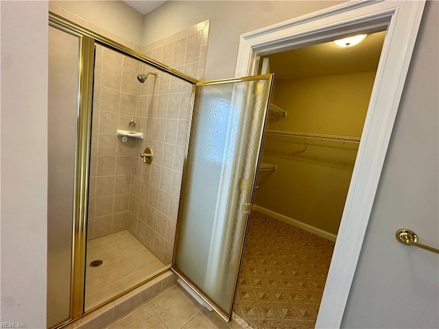 bathroom featuring a shower with shower door