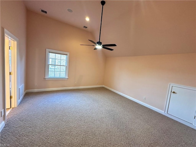 unfurnished room with carpet, ceiling fan, and high vaulted ceiling