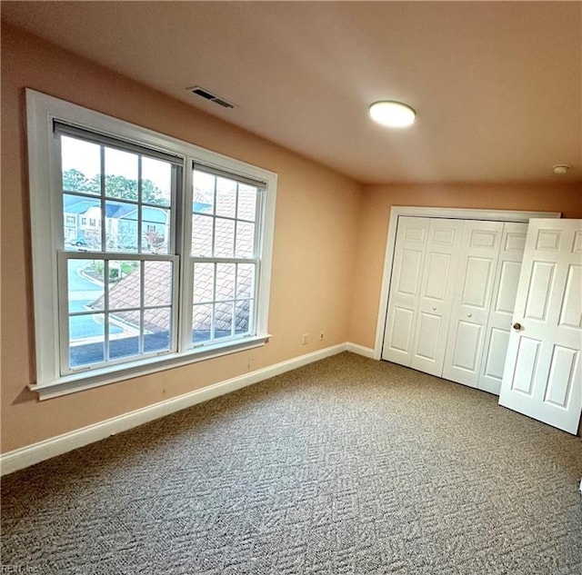 unfurnished bedroom with carpet and a closet