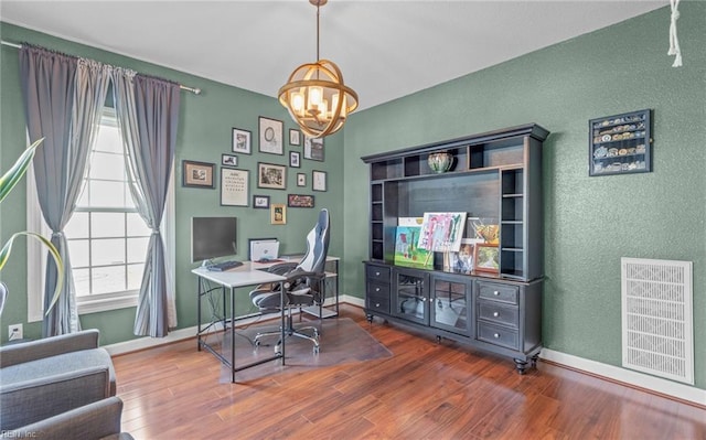 office space featuring hardwood / wood-style floors and a notable chandelier