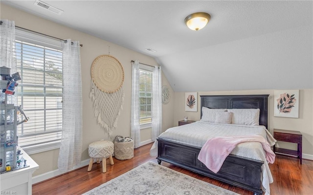 bedroom featuring hardwood / wood-style flooring and lofted ceiling