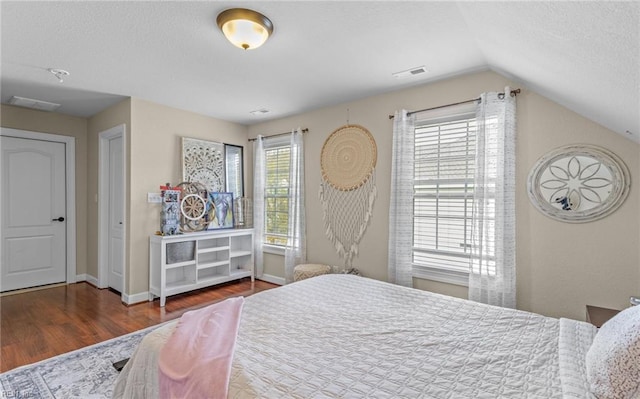 bedroom with dark hardwood / wood-style flooring and vaulted ceiling