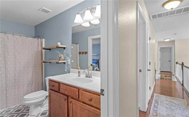 bathroom featuring wood-type flooring, vanity, and toilet