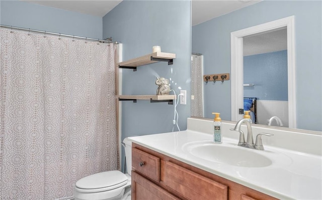 bathroom featuring vanity and toilet