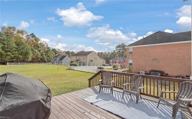 deck with area for grilling and a lawn