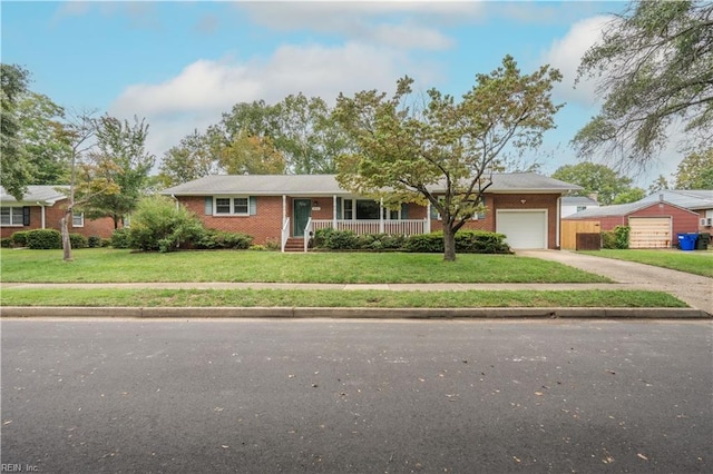 single story home with covered porch, a front yard, and a garage