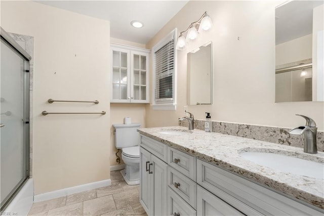 full bathroom with vanity, toilet, and bath / shower combo with glass door