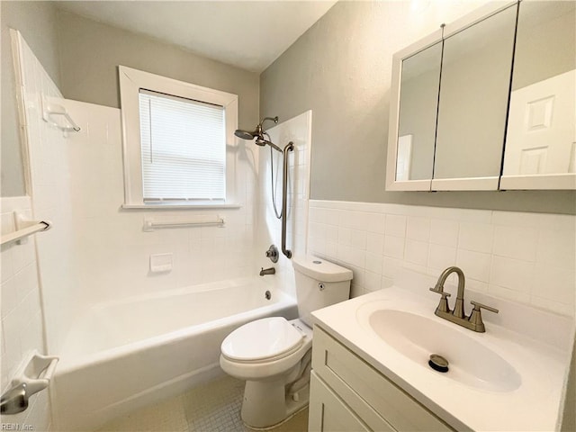 full bathroom with toilet, vanity, tile walls, and tiled shower / bath