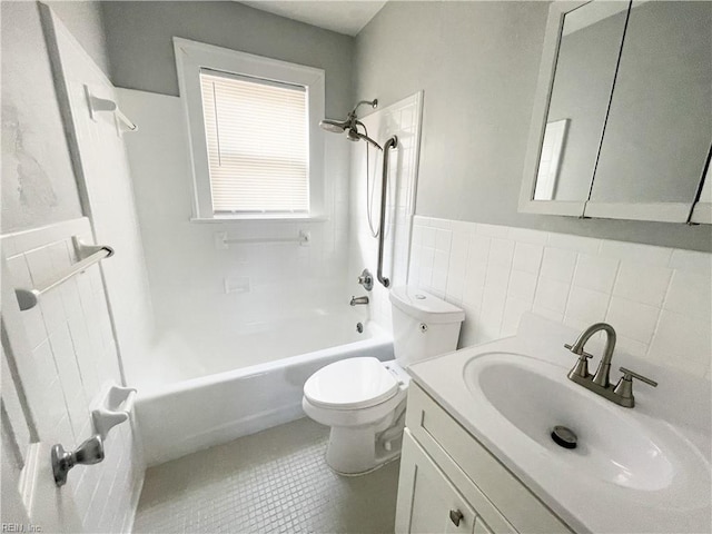 full bathroom featuring tile patterned flooring, toilet, shower / tub combination, vanity, and tile walls