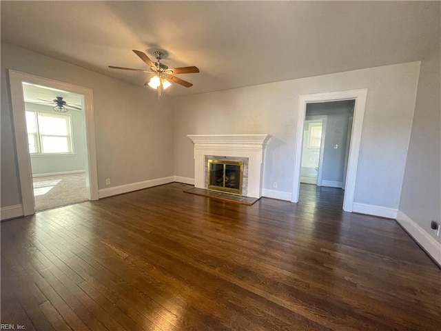 unfurnished living room with ceiling fan and dark hardwood / wood-style floors