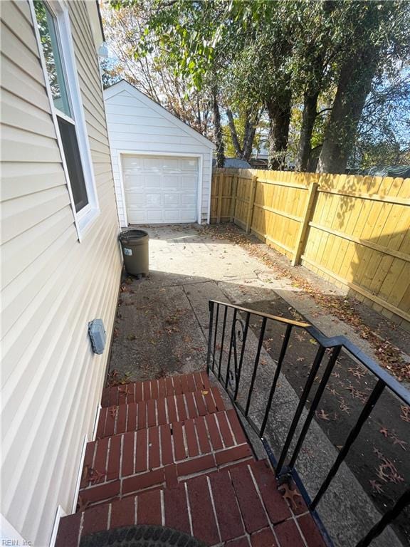 view of patio / terrace featuring a garage and an outdoor structure