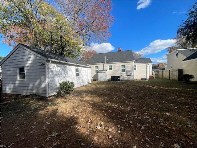 rear view of house featuring a lawn