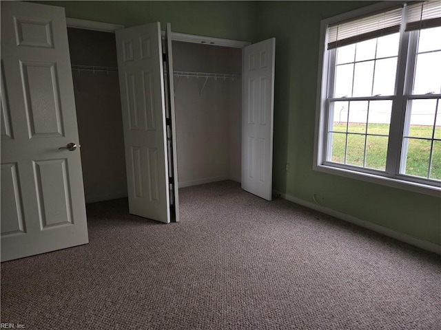 unfurnished bedroom featuring carpet flooring and a closet