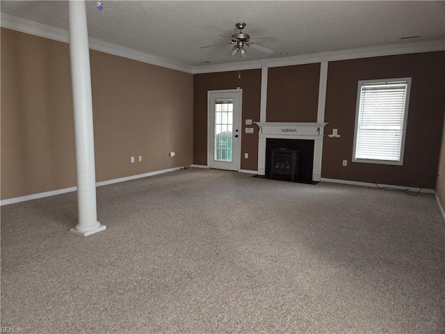 unfurnished living room with ornate columns, ceiling fan, carpet, and ornamental molding