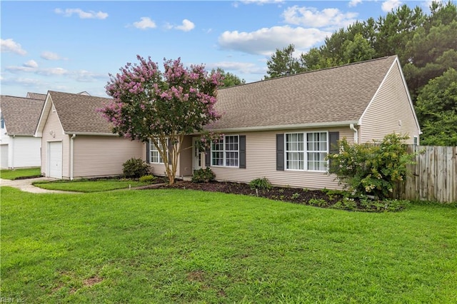 ranch-style home featuring a garage and a front lawn