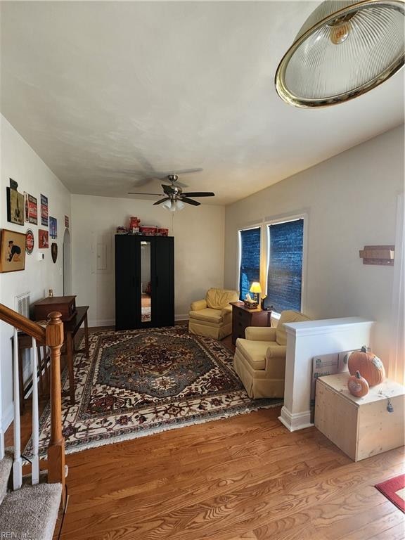 living room with ceiling fan and light hardwood / wood-style floors