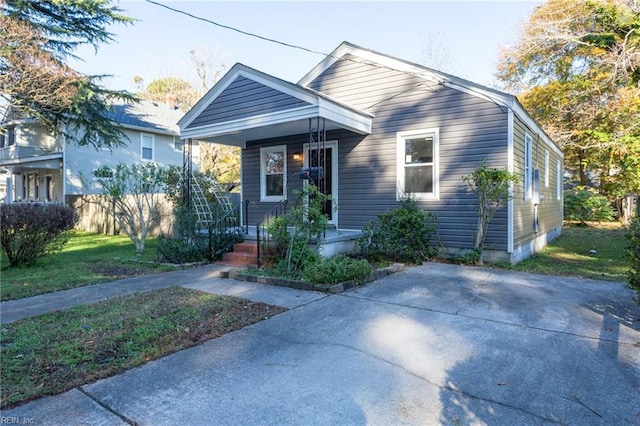 bungalow featuring a front yard and covered porch