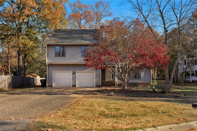 view of front of home with a front lawn and a garage