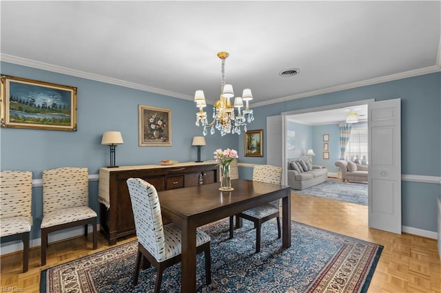 dining space featuring light parquet flooring, an inviting chandelier, and crown molding