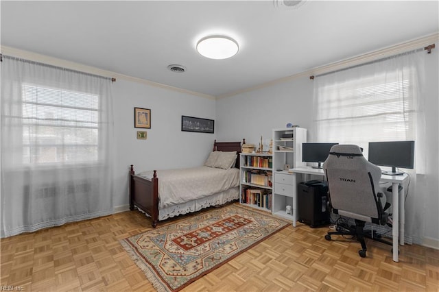 bedroom with ornamental molding and light parquet flooring