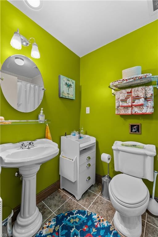 bathroom with tile patterned flooring and toilet