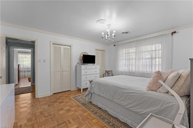 bedroom featuring light parquet floors, multiple closets, crown molding, and multiple windows