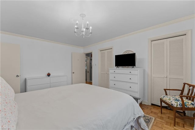 bedroom with crown molding, light parquet floors, and two closets