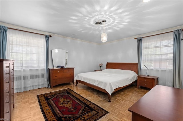 bedroom featuring ornamental molding and light parquet floors