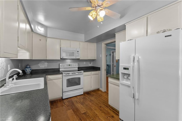 kitchen featuring white appliances, white cabinetry, dark wood-type flooring, and sink