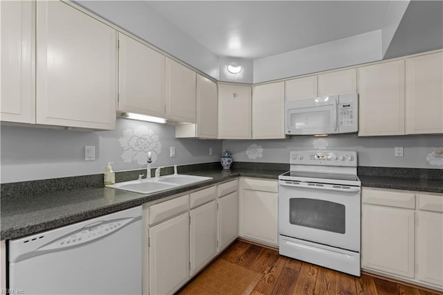 kitchen with white cabinetry, white appliances, sink, and dark wood-type flooring